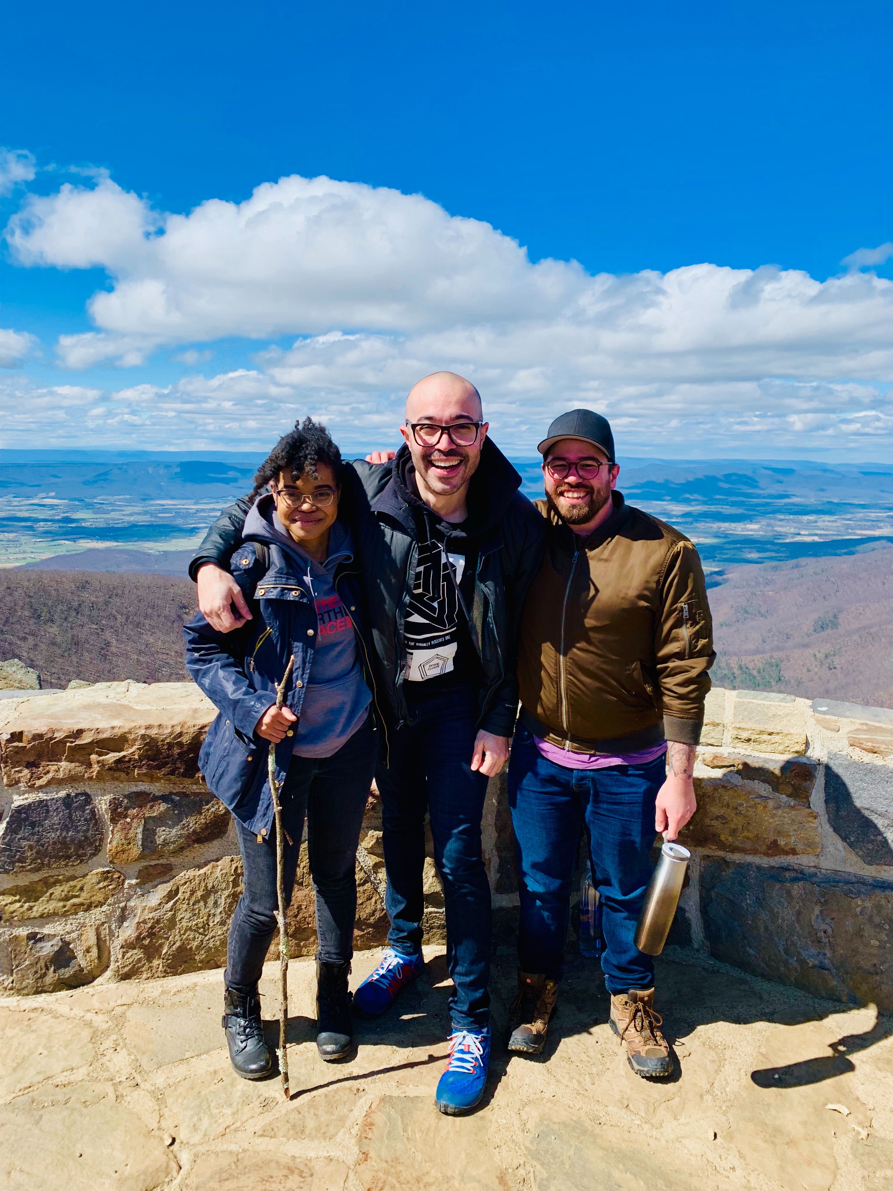 Devon, Brittany and Nathan posing at the top of a peak at Shenandoah National Park